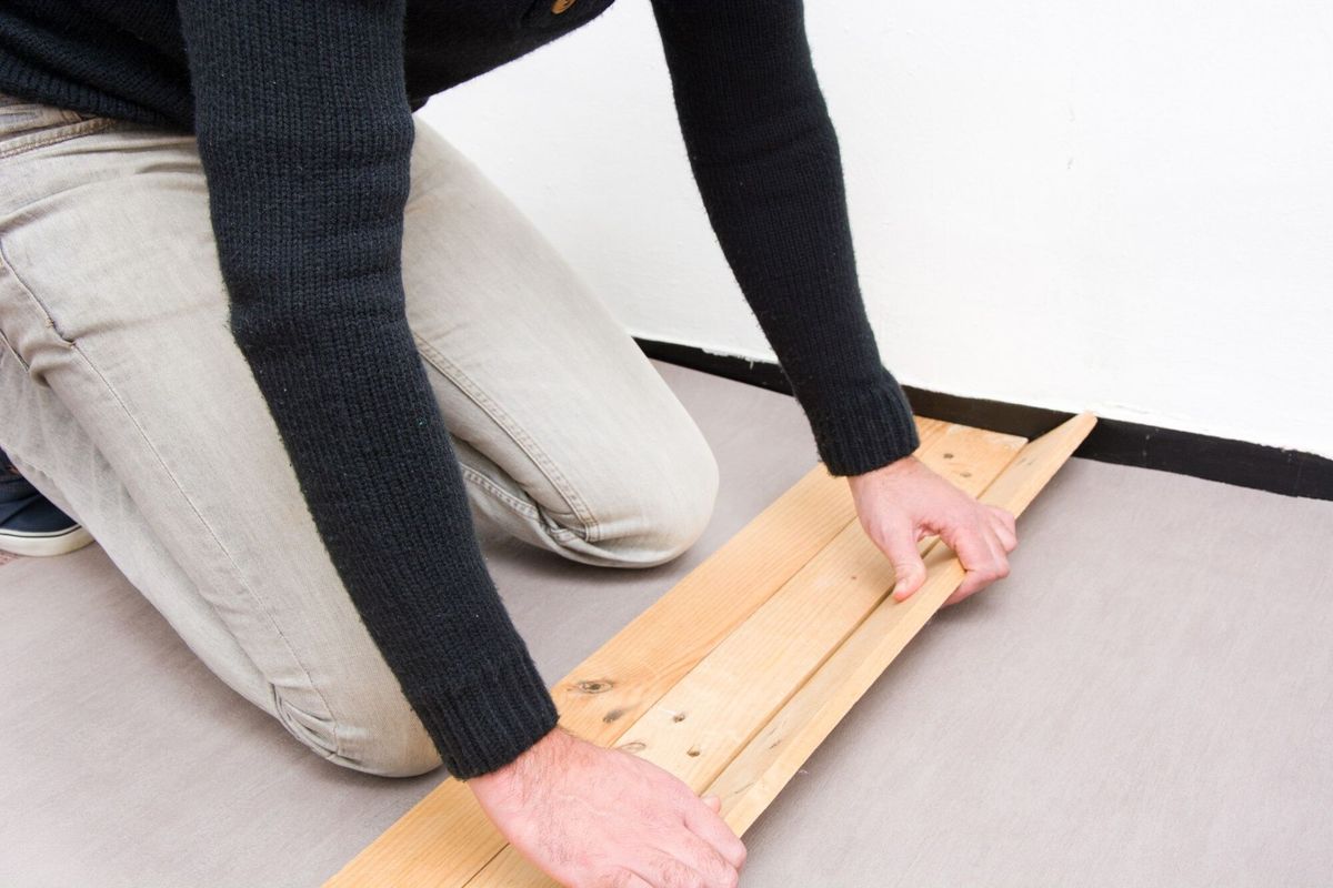 Man putting wood floor