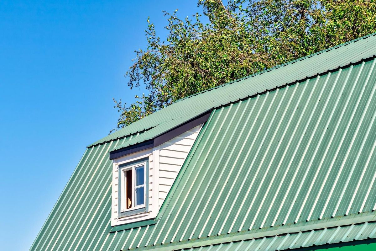 The window on green roof of a farm barn