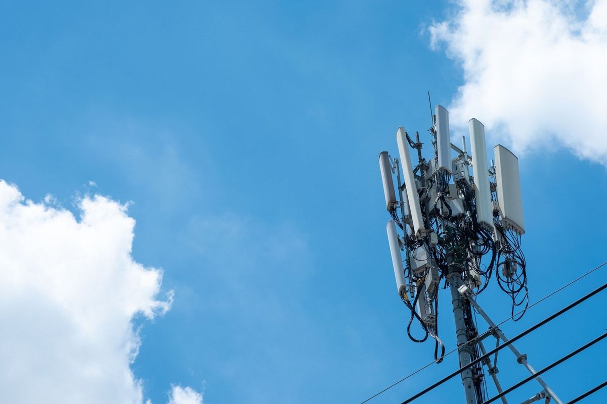 Communication antenna tower with blue sky, Telecoms technology.