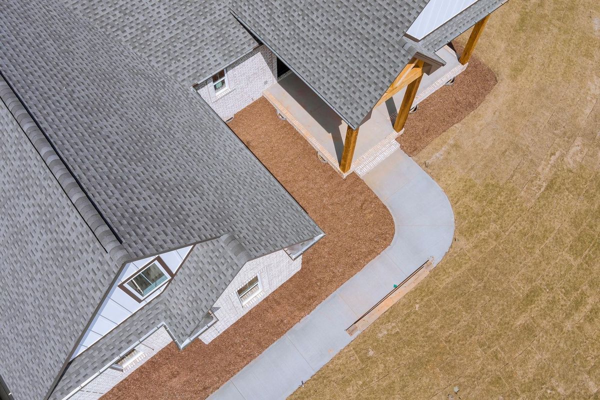 Aerial view of newly installed roof with asphalt shingles with bitumen tiles on new home the rooftop