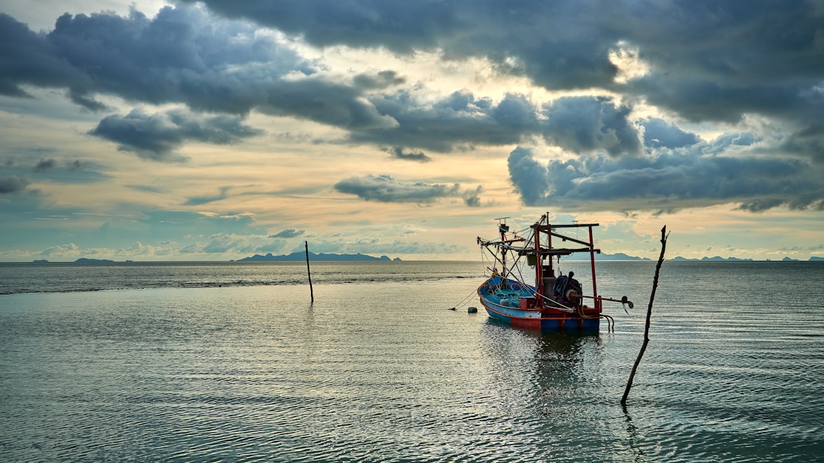 a fishing boat in the middle of a body of water