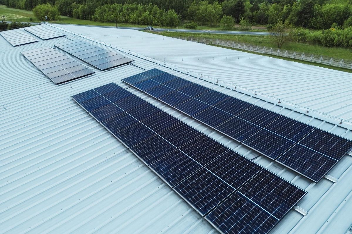 Large roof with solar panels in rural green landscape