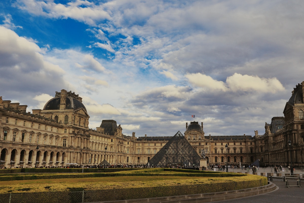 a large building with a pyramid in front of it