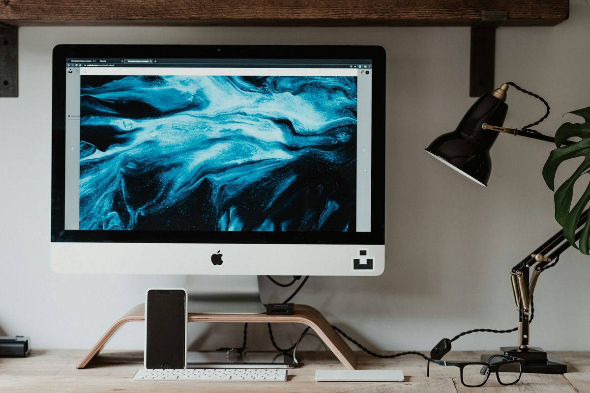 silver imac on white table