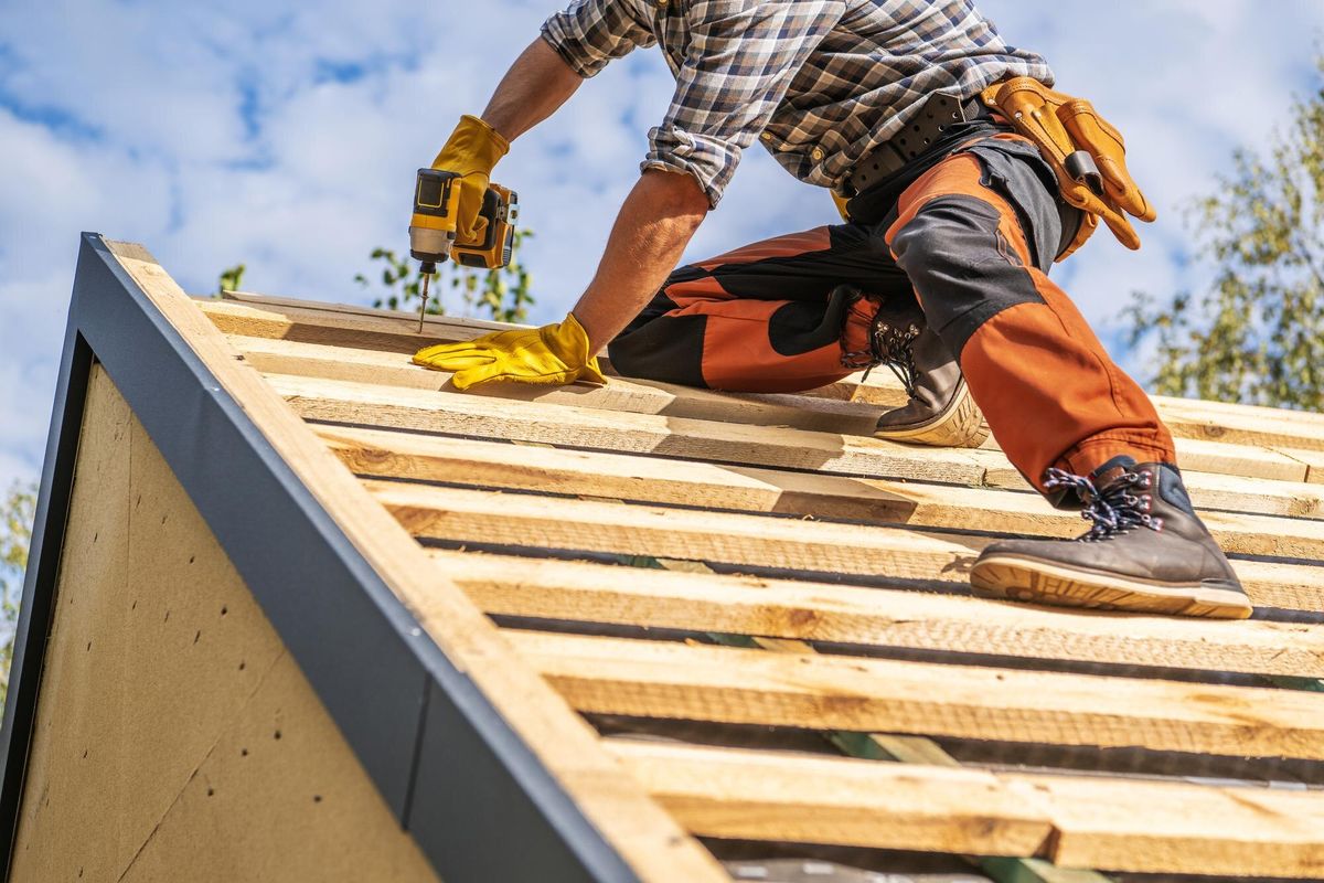 Roofing Contractor Attaching Wooden Elements to the House Roof