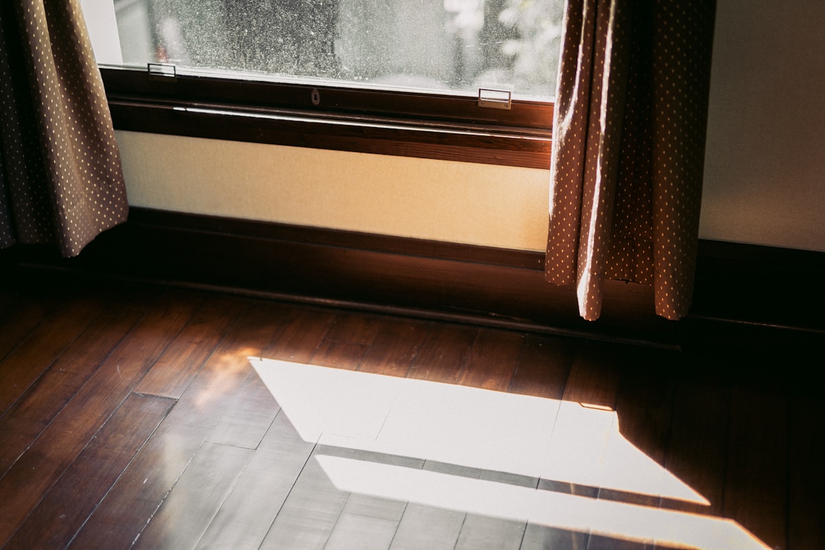 a room with a window and a wooden floor