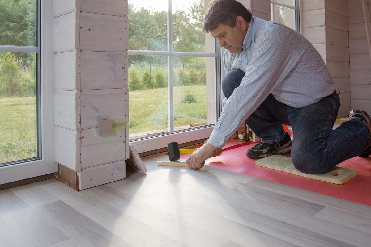 Man installing new laminated wooden floor