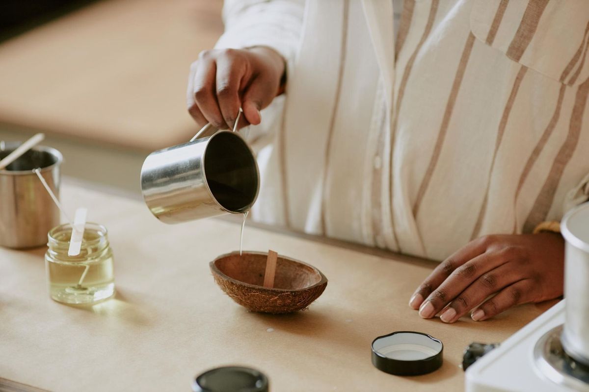 Pouring liquid into bowl for aromatherapy candle making
