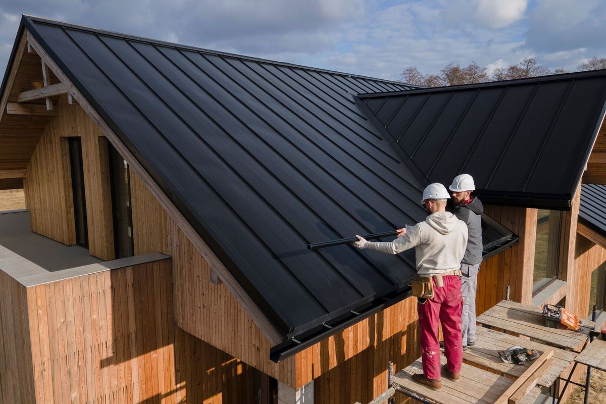 Full shot roofers working together with helmets