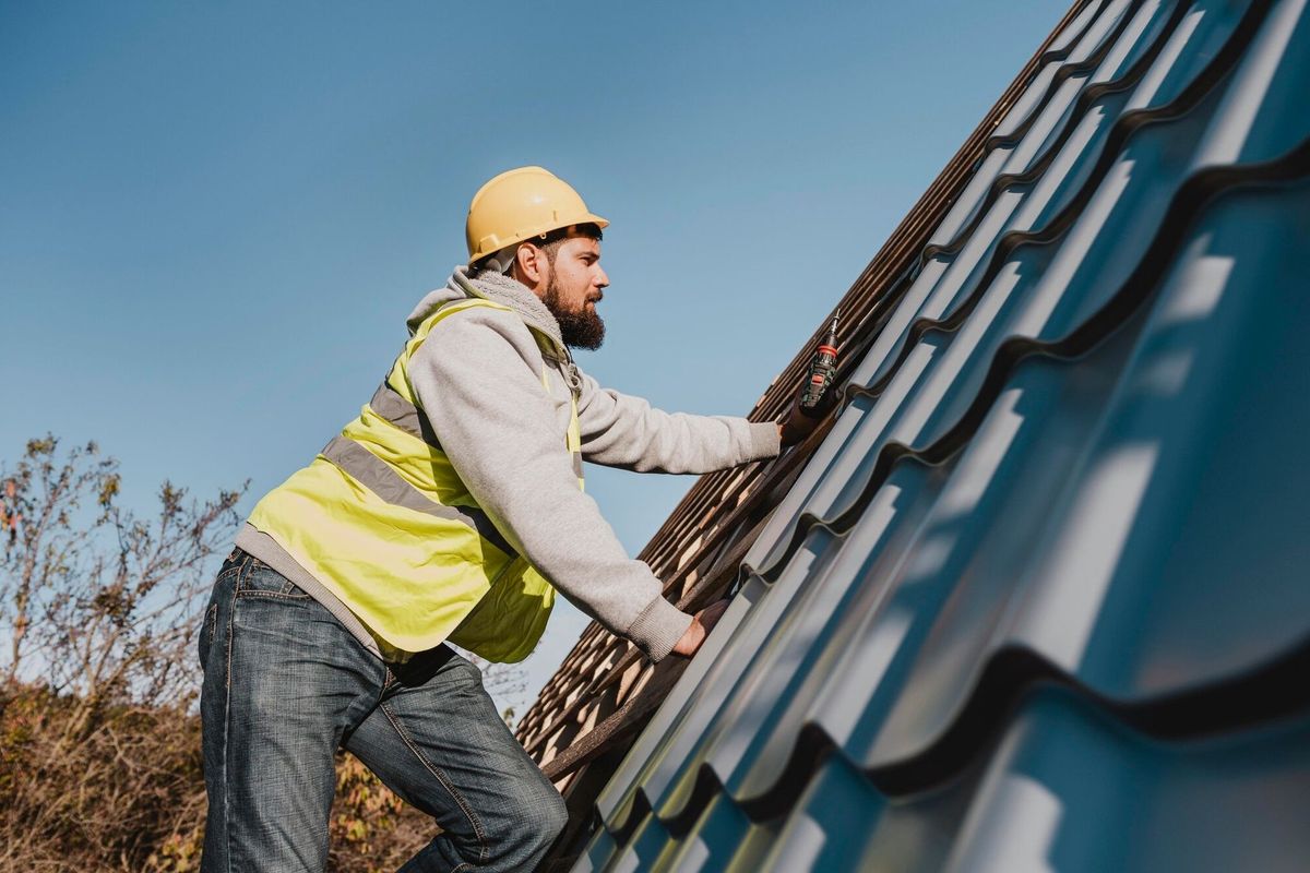 Side view man working on roof