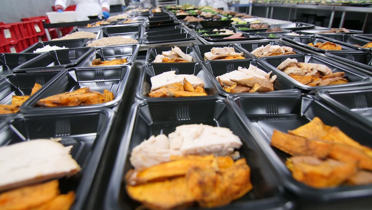 a bunch of trays filled with different types of food