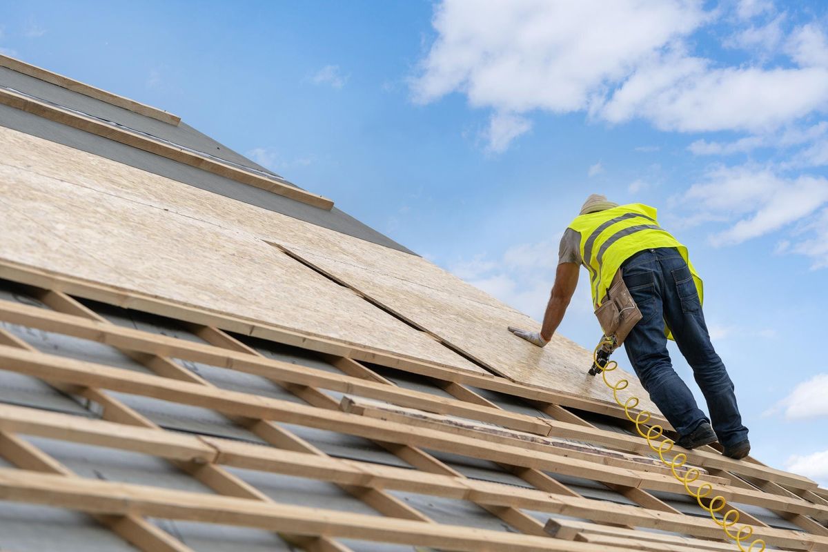 Building construction process of new wooden roof on wood frame house