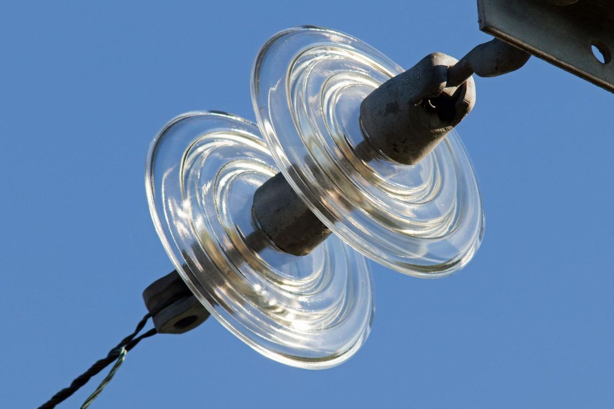Low angle view of electric lamp against blue sky