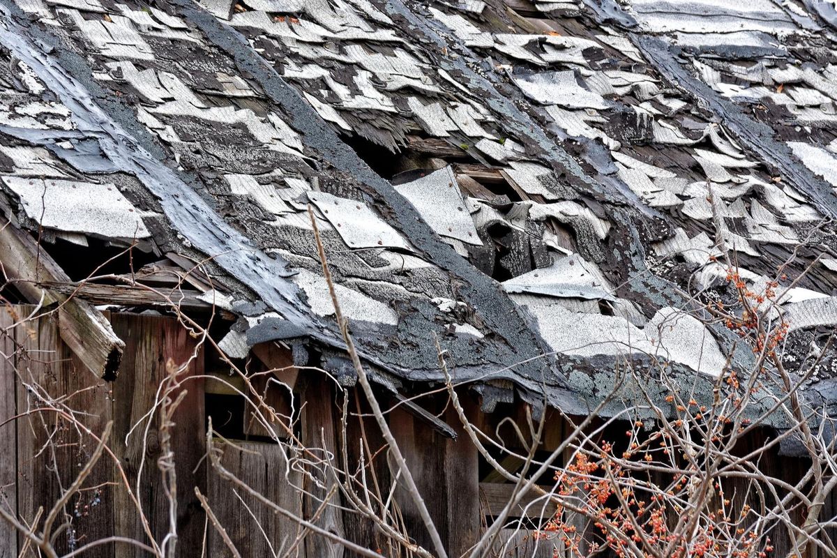 Damaged roof of abandoned house