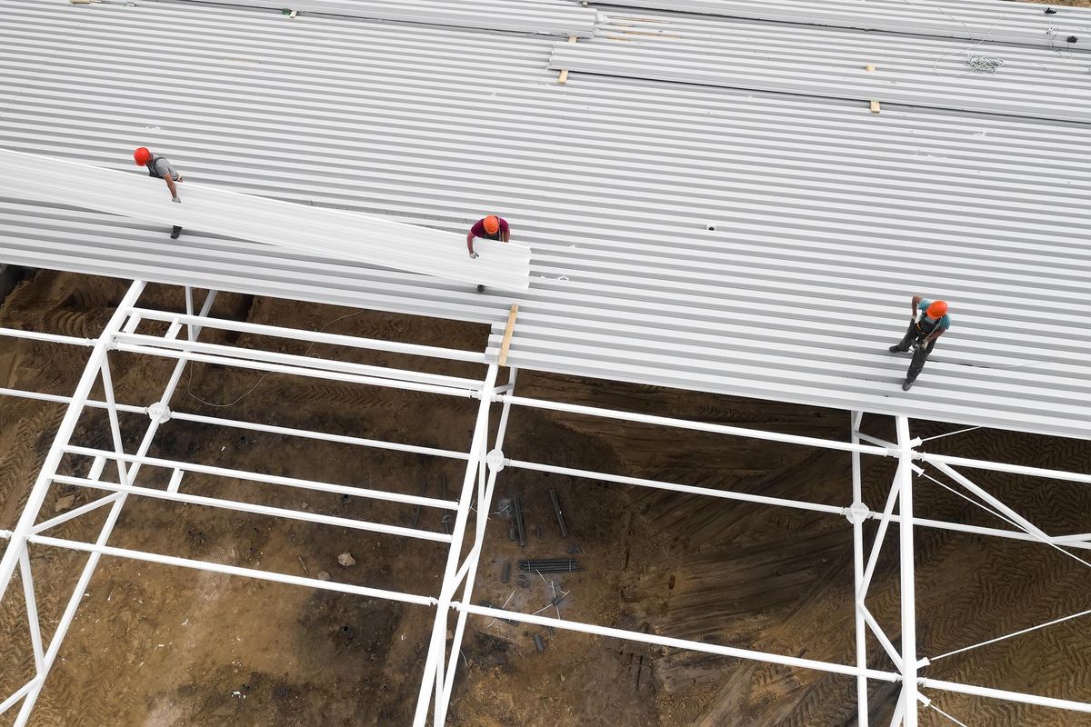 Workers install the roof Top view from a drone