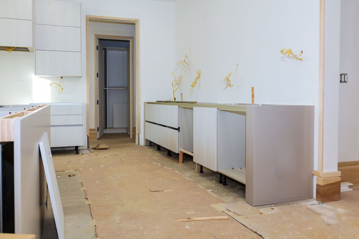  kitchen cabinets in various stages of installation base for island in center