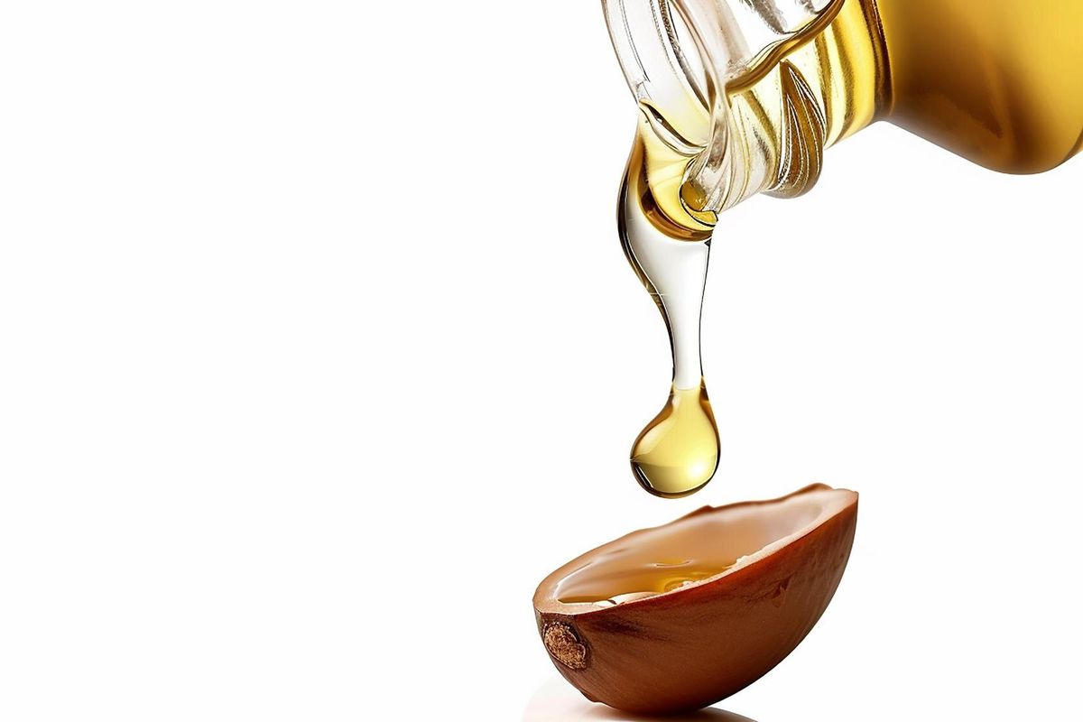 a bottle of oil is being poured into a bowl