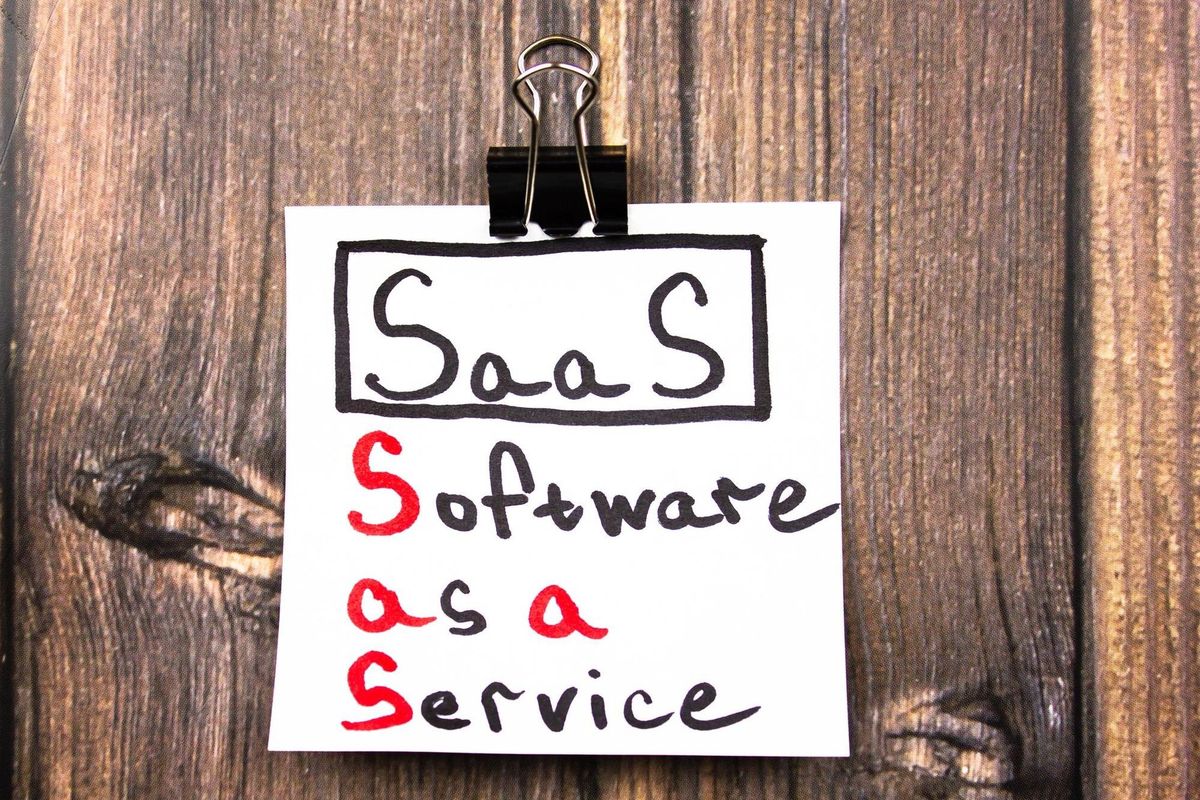 SaaSSoftware as a Service text on a sheet on the table SaaS concept