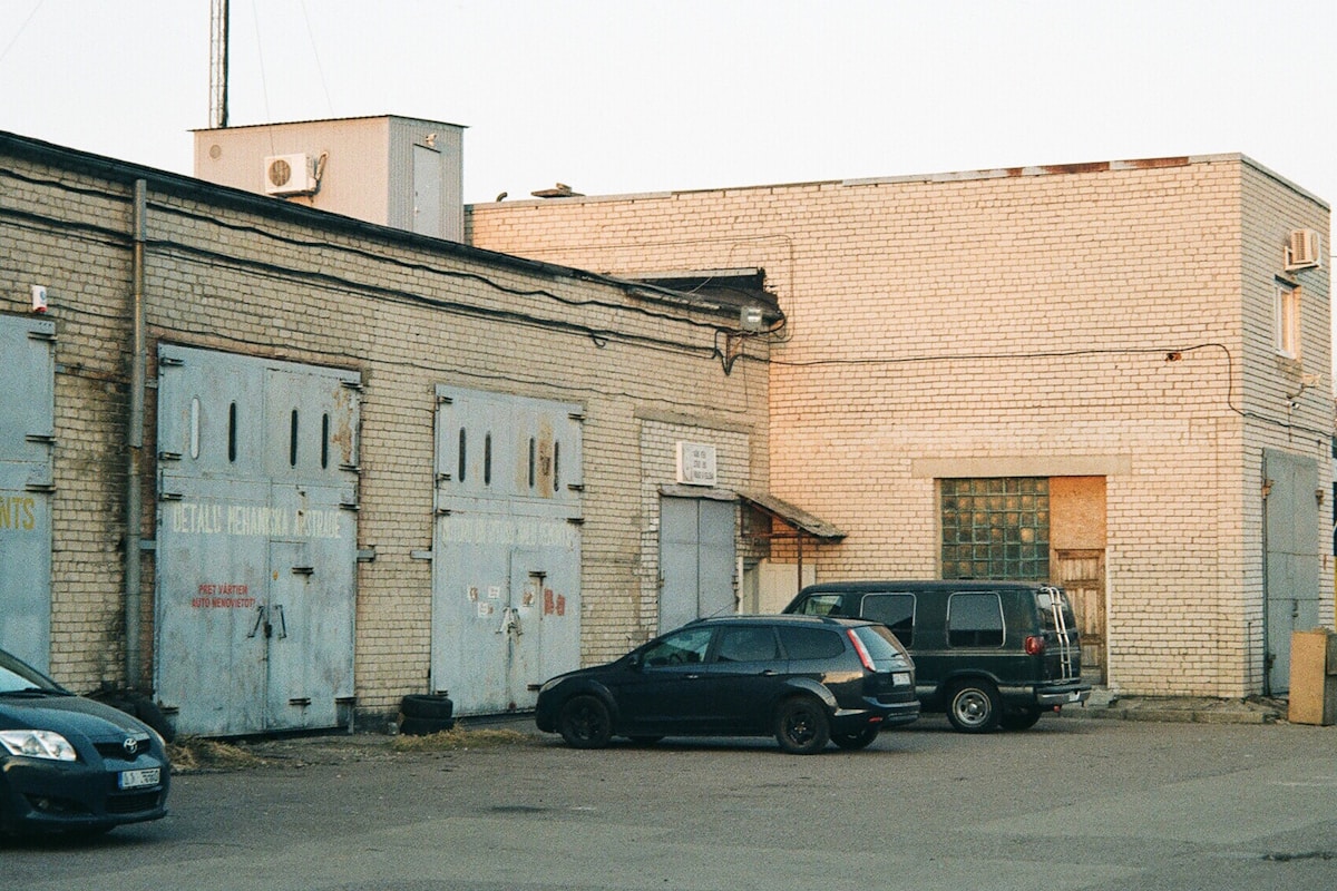 a brick building with cars parked in front of it