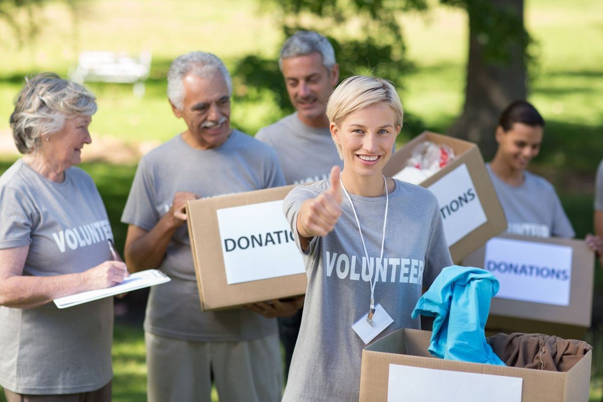 Happy volunteer blonde with thumb up 