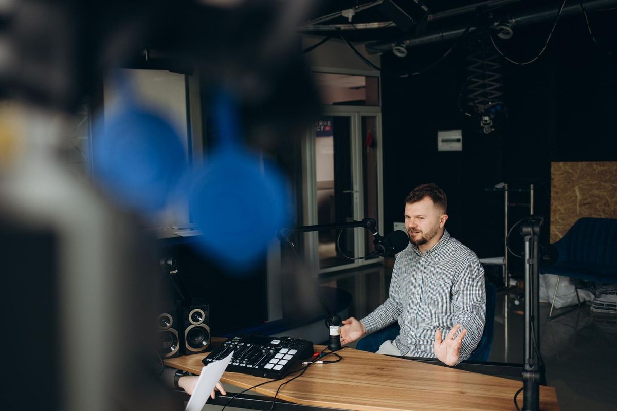 Portrait of happy young man working as radio host at radio station