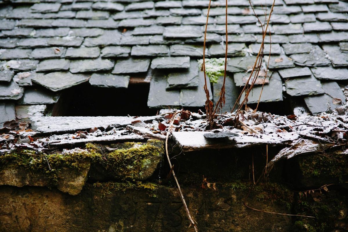 Close-up of broken roof on house