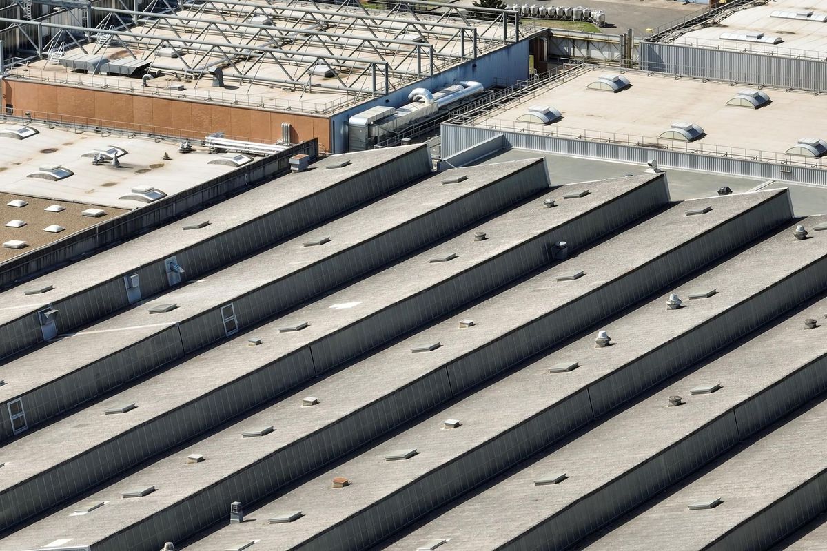 Aerial view of solar panels installed as shade roof over parking lot with parked cars for effective generation of clean electricity Photovoltaic technology integrated in urban infrastructure