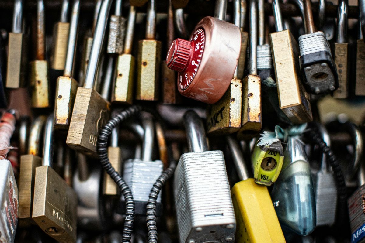 a bunch of padlocks that are attached to a wall